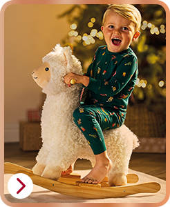 Child on plush rocking llama toy