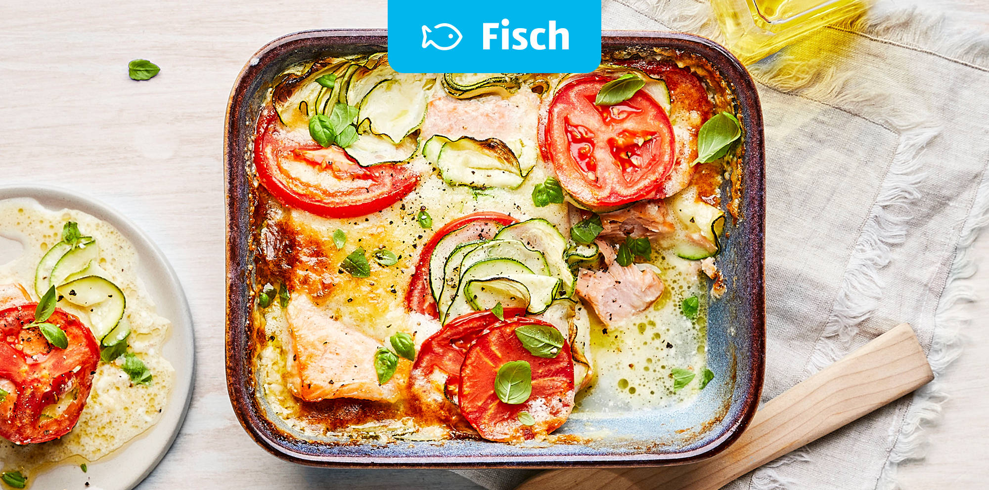 Fischauflauf mit Tomaten und Zucchini.
