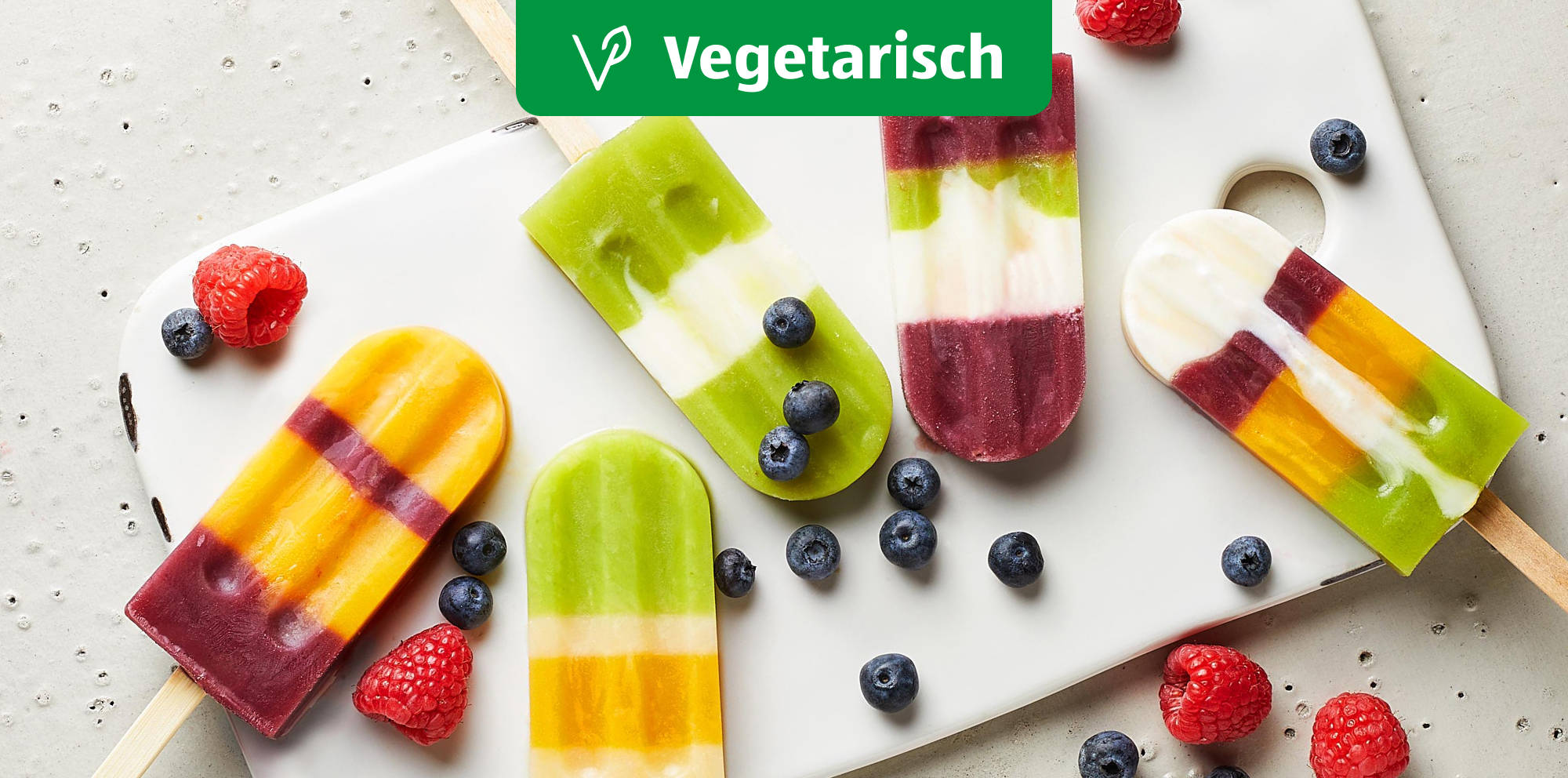 Colorful vegetarian fruit ice pops with berries.