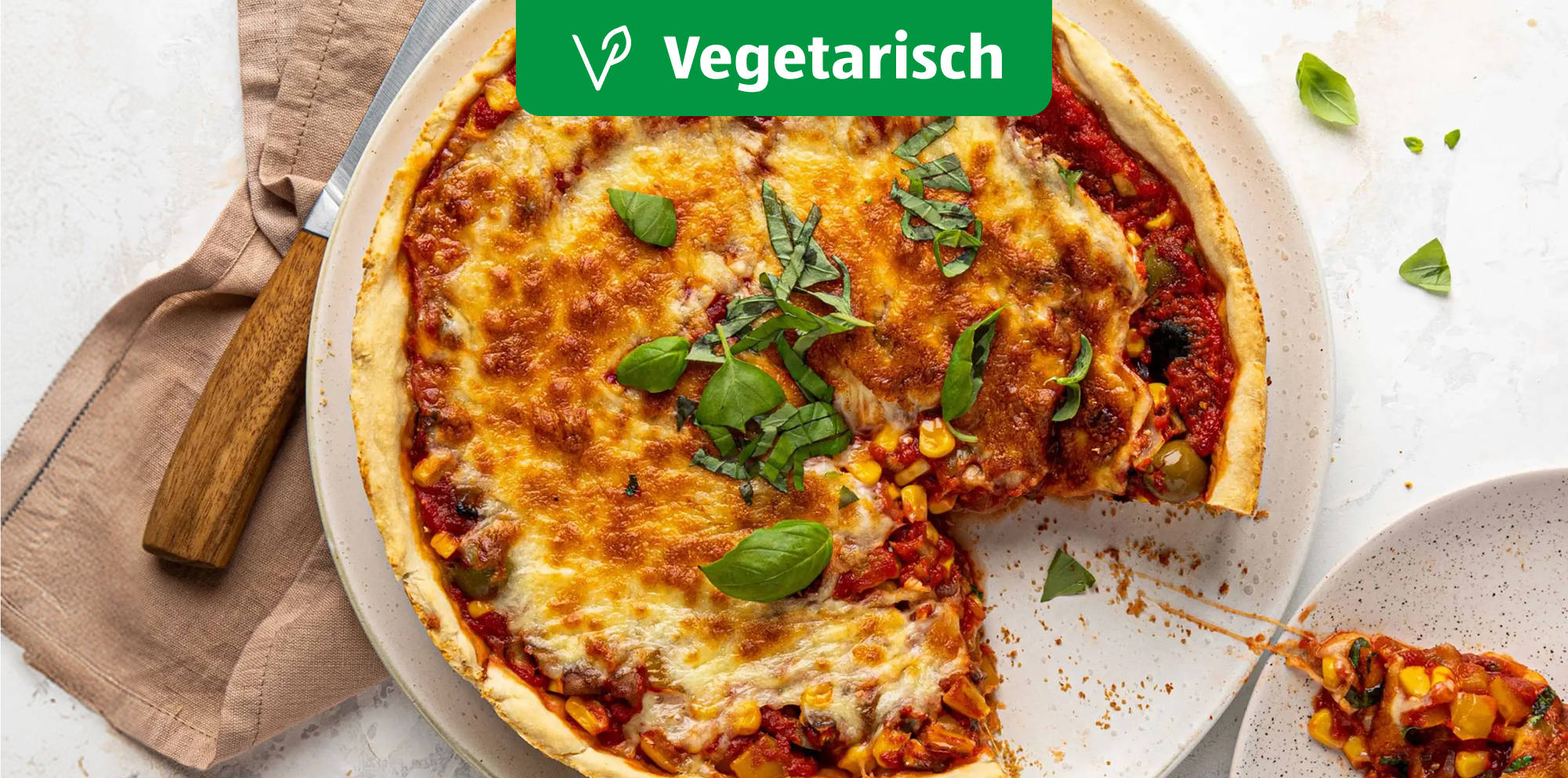 Vegetarian deep-dish pizza with fresh basil.