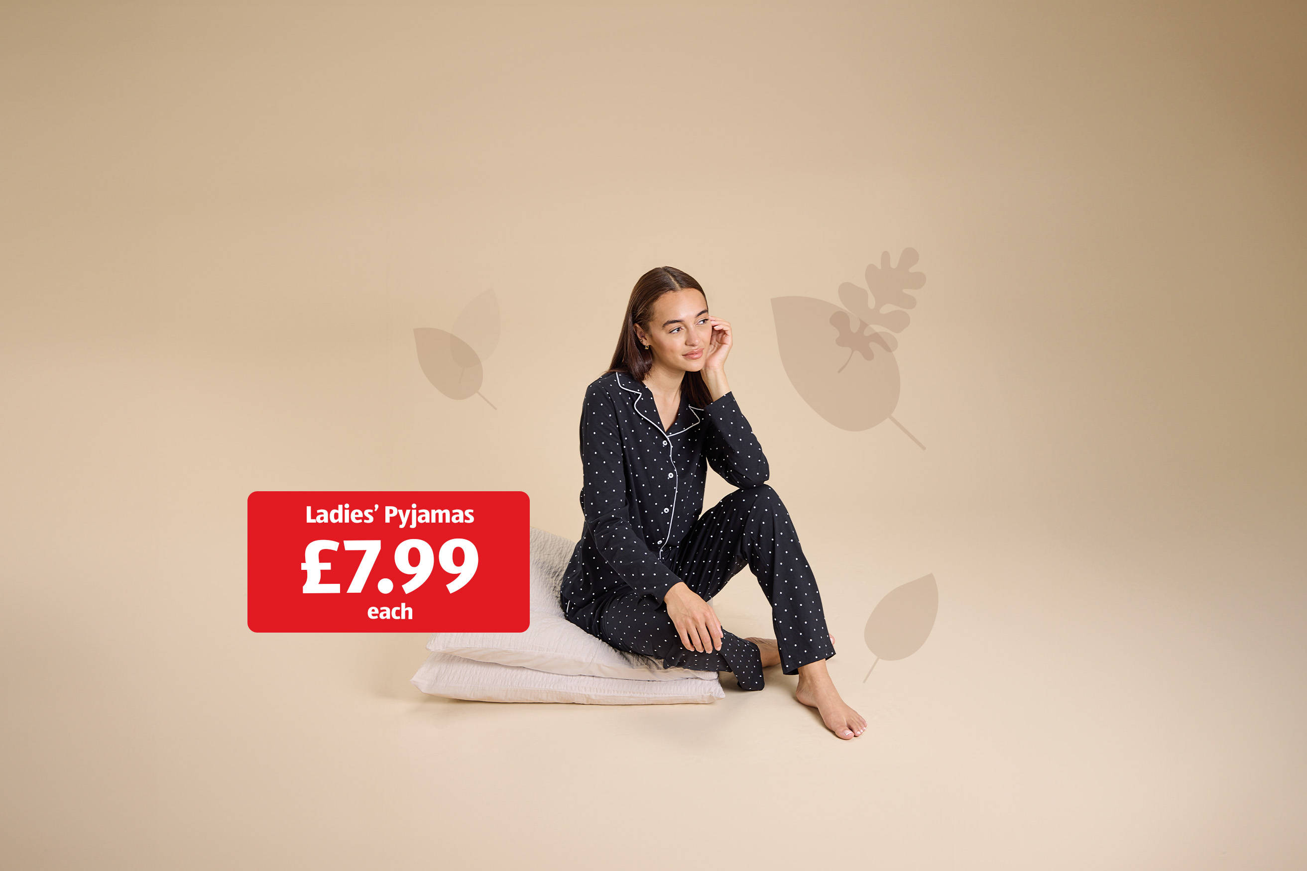 Woman in polka dot pyjamas sat on cushions