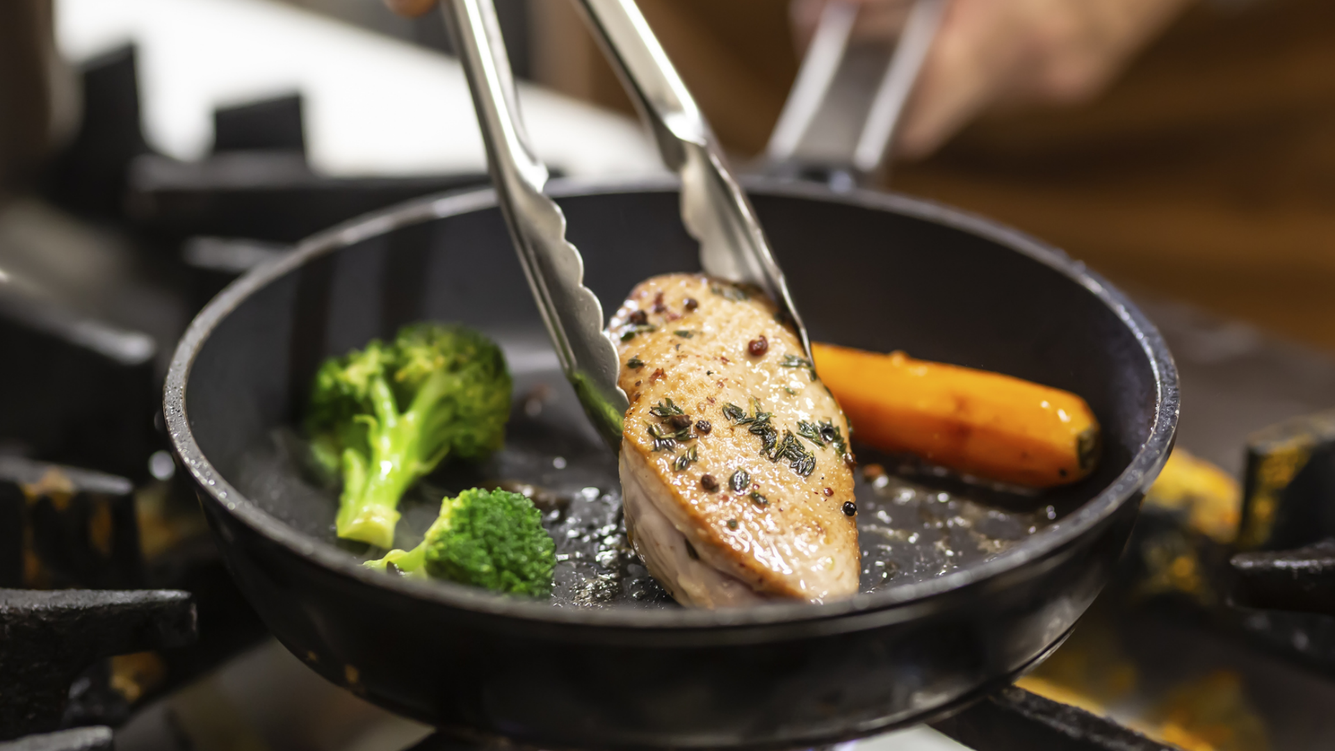 Geflügelbrust mit Gemüse in einer Pfanne braten.