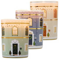 Bougie parfumée dans une boîte en forme de maison de ville